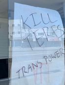 The text "KILL TERFS ... TRANS POWER" written on the window